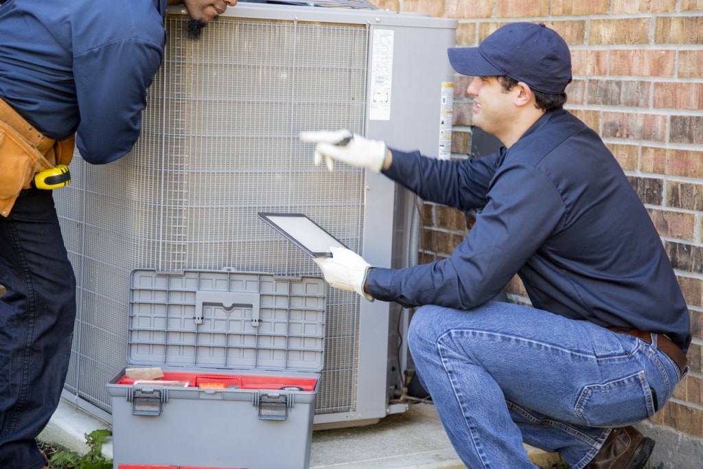 technician repairing an ac system in Portsmouth, VA