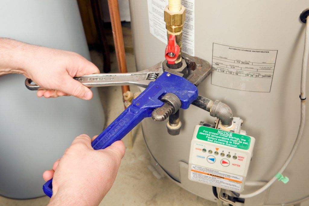 plumber repairing a hot water heater in Norfolk, VA