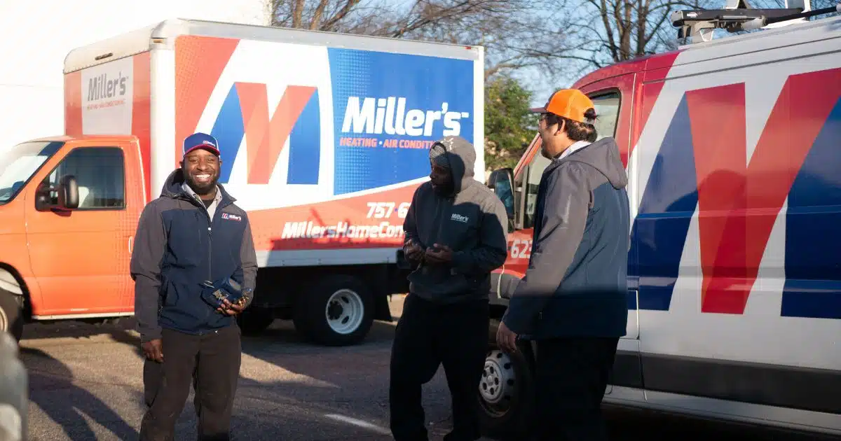 image of Miller's HVAC technicians standing by their work truck